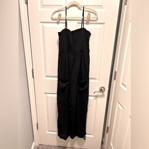 Black CUPSHE jumpsuit with tie straps and pockets in the front